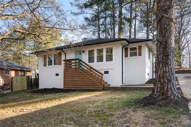 rear view of house with a yard