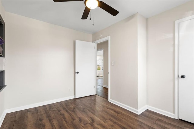 unfurnished bedroom featuring dark wood-type flooring and ceiling fan