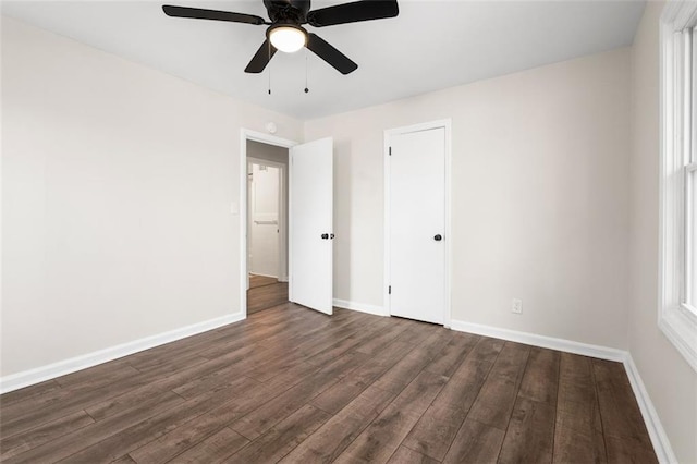 unfurnished bedroom featuring dark hardwood / wood-style floors and ceiling fan