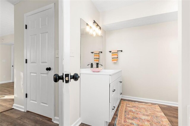 kitchen with sink, butcher block counters, stainless steel dishwasher, and white cabinets