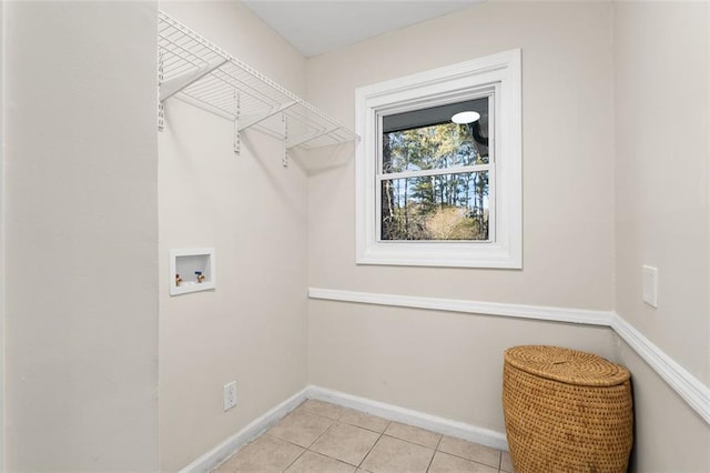 clothes washing area featuring washer hookup and light tile patterned floors