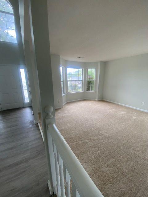 spare room featuring dark colored carpet