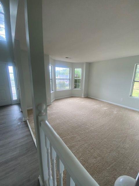 unfurnished room with dark colored carpet