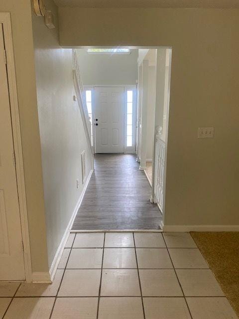 doorway with light tile patterned floors