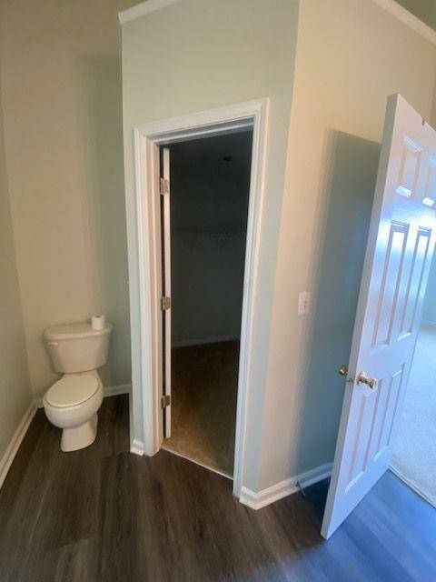 bathroom with hardwood / wood-style flooring and toilet