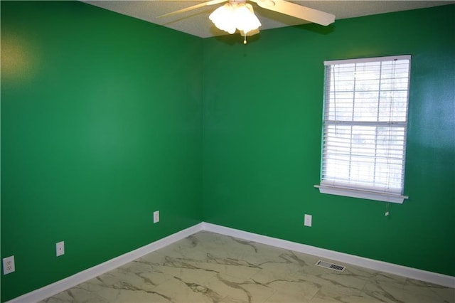 spare room featuring a textured ceiling and ceiling fan