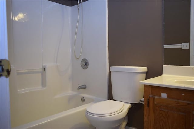 full bathroom featuring washtub / shower combination, vanity, and toilet