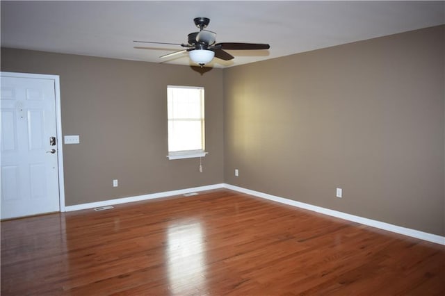 empty room featuring hardwood / wood-style flooring and ceiling fan