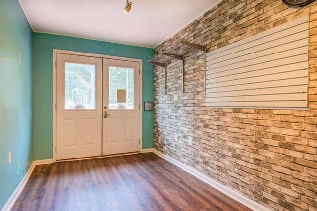 doorway to outside with french doors, brick wall, and dark hardwood / wood-style floors