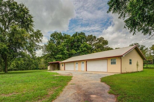 garage with a lawn and a carport