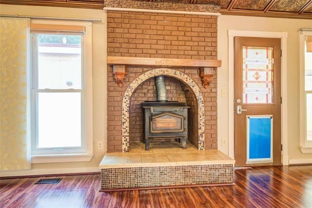 interior details featuring hardwood / wood-style floors and a wood stove