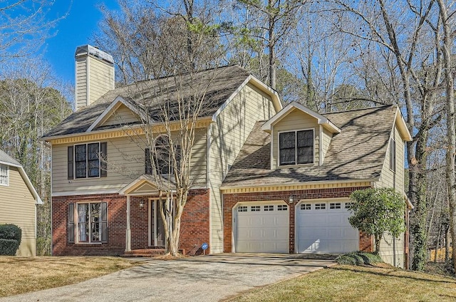 view of front of house featuring driveway, a garage, brick siding, a chimney, and a front yard