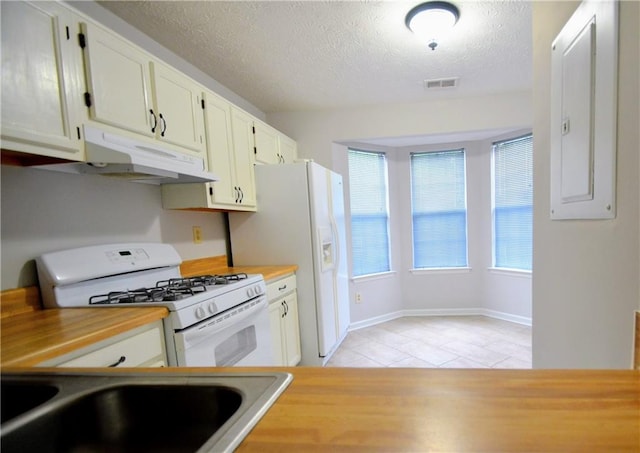 775 Heritage Valley Rd, Norcross, GA 30093 - kitchen with white appliances, under cabinet range hood, a textured ceiling, light tile patterned floors, and light countertops