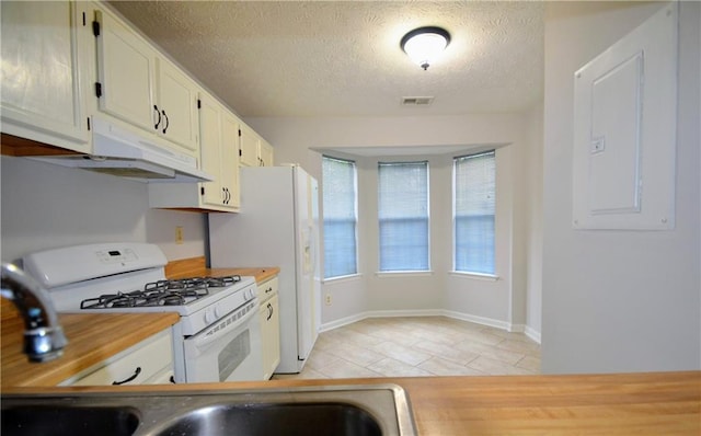 775 Heritage Valley Rd, Norcross, GA 30093 - kitchen featuring white appliances, light tile patterned flooring, under cabinet range hood, white cabinetry, and a textured ceiling