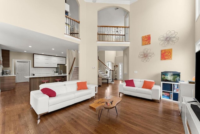 12350 Broadleaf Ln, Johns Creek, GA 30005 - living room with a high ceiling, stairs, dark wood-style flooring, arched walkways, and recessed lighting