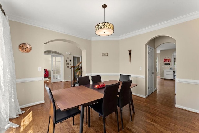 12350 Broadleaf Ln, Johns Creek, GA 30005 - dining room featuring arched walkways, crown molding, wood finished floors, and baseboards
