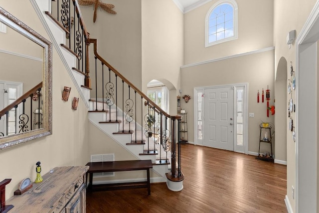12350 Broadleaf Ln, Johns Creek, GA 30005 - foyer featuring arched walkways, plenty of natural light, wood finished floors, a high ceiling, and stairway