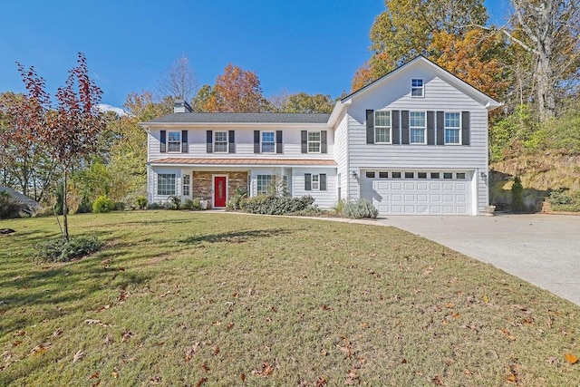 view of front of home featuring a front lawn and a garage