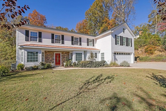 front of property featuring central AC unit, a front yard, and a garage