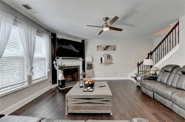 living room with ceiling fan and dark wood-type flooring