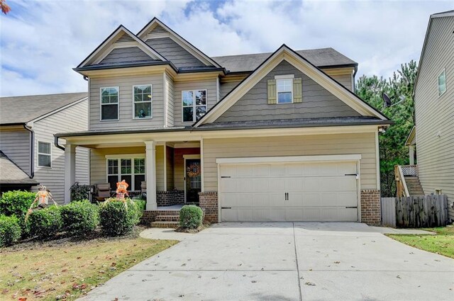 craftsman-style house featuring covered porch and a garage