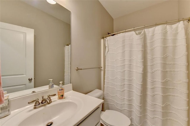 bathroom featuring vanity, toilet, and a shower with shower curtain