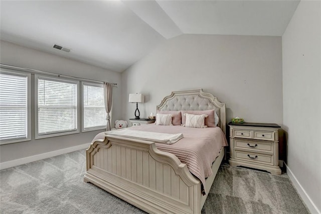 carpeted bedroom with vaulted ceiling