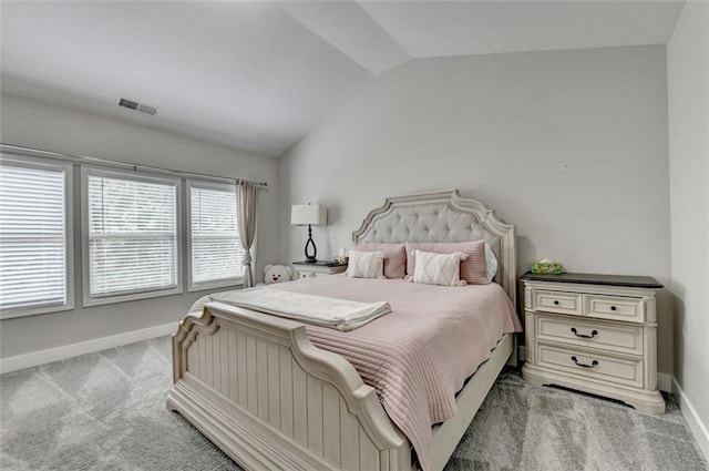 carpeted bedroom with vaulted ceiling