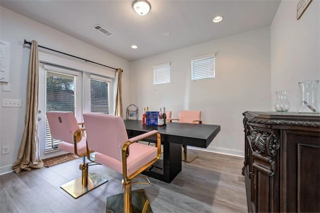 dining space with hardwood / wood-style floors