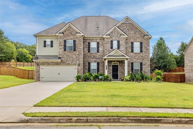 craftsman-style home featuring a garage and a front lawn