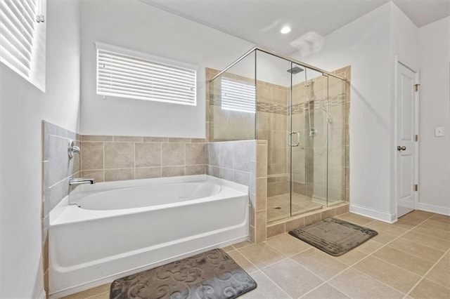 bathroom with tile patterned floors and shower with separate bathtub