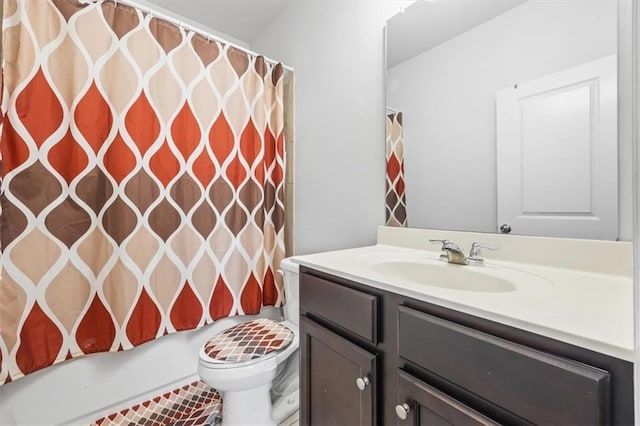 full bathroom with vanity, toilet, and shower / tub combo with curtain