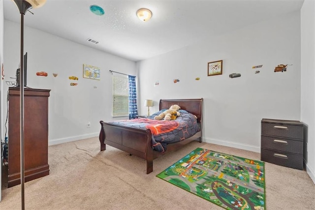 bedroom featuring light carpet