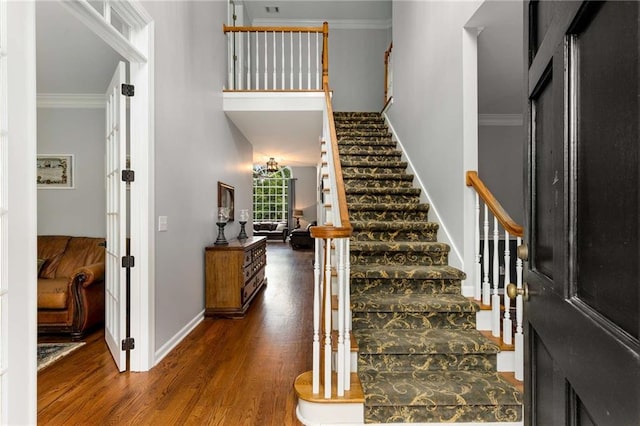 entryway featuring crown molding and dark wood-type flooring