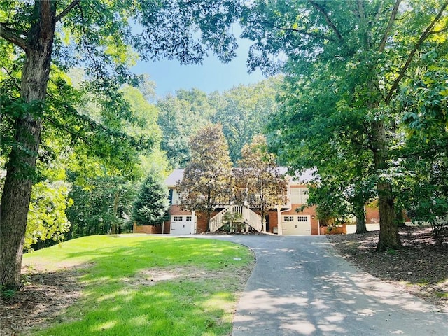 view of front facade with a garage and a front lawn