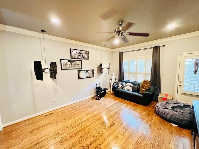 interior space featuring a healthy amount of sunlight, crown molding, and ceiling fan