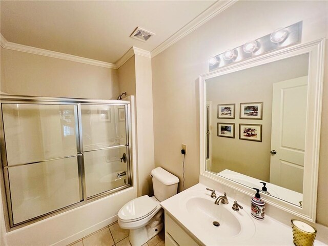 full bathroom featuring bath / shower combo with glass door, vanity, ornamental molding, toilet, and tile patterned floors