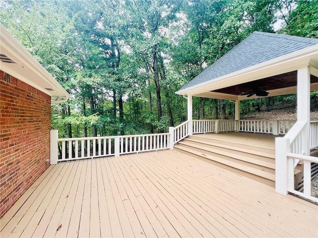 wooden deck featuring ceiling fan