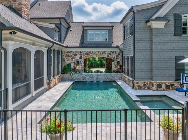 view of pool featuring a pool with connected hot tub and a patio area