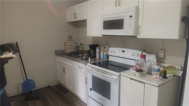 kitchen featuring dark hardwood / wood-style floors, white cabinetry, sink, and white appliances