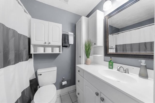 bathroom with toilet, baseboards, and vanity