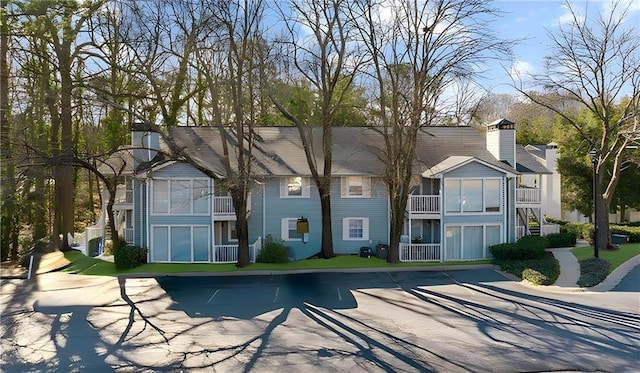 back of property featuring a residential view and stairway