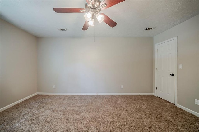 empty room featuring visible vents, baseboards, carpet floors, and ceiling fan