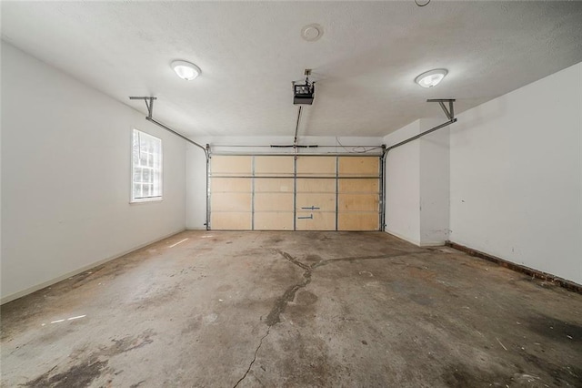 garage with baseboards and a garage door opener