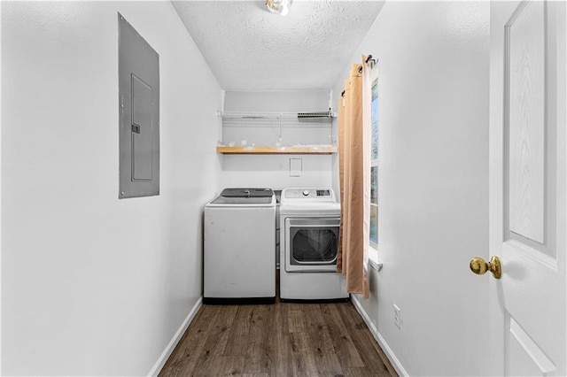 laundry area featuring electric panel, a textured ceiling, washer and clothes dryer, wood finished floors, and laundry area