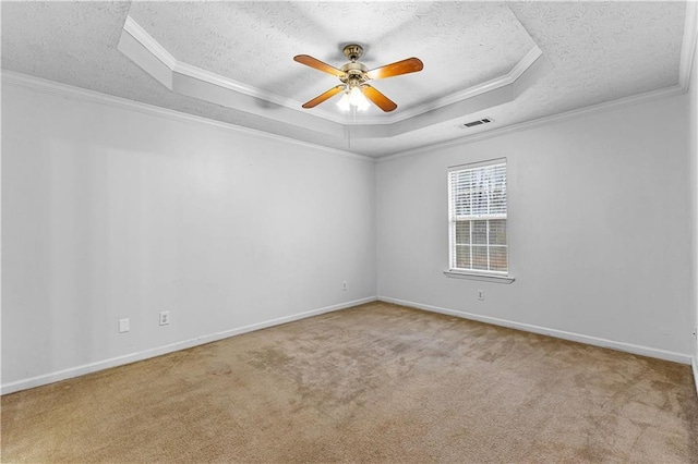 carpeted spare room with a ceiling fan, a textured ceiling, a raised ceiling, and crown molding