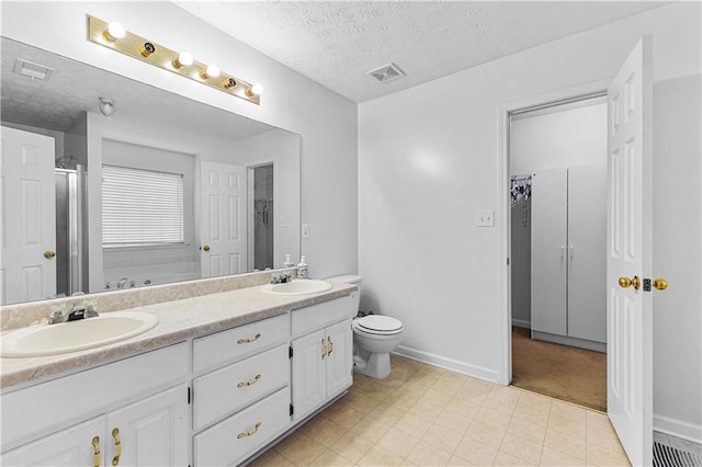 full bathroom featuring toilet, visible vents, a sink, and a textured ceiling
