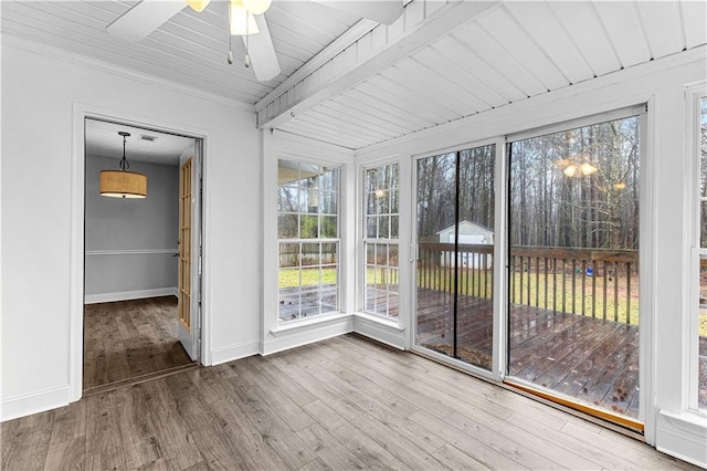 unfurnished sunroom featuring baseboards, wood finished floors, and a deck