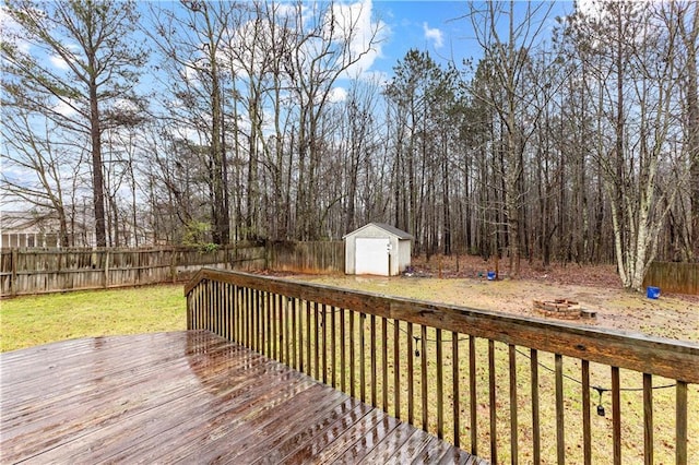 wooden deck with a lawn, a fenced backyard, an outdoor structure, and a storage shed
