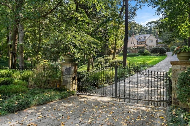 view of gate featuring a yard